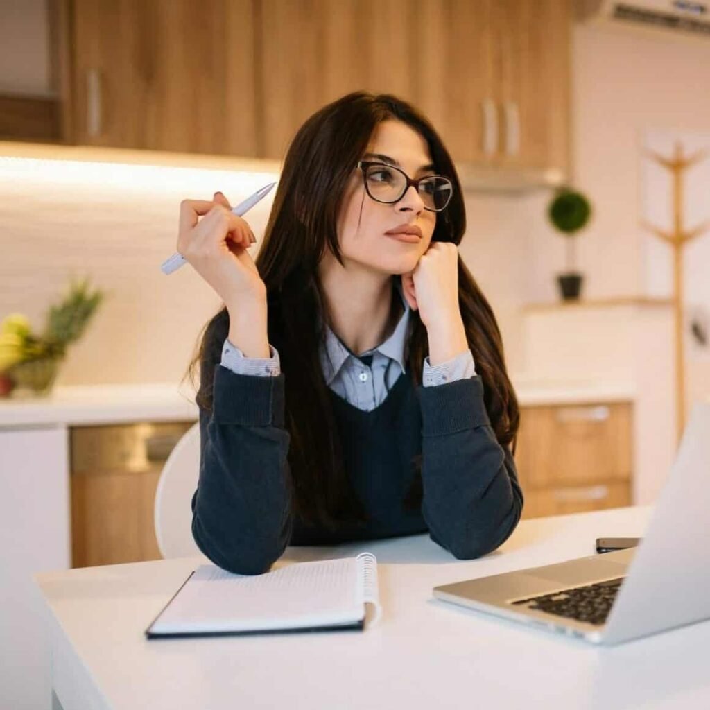 portrait of beautiful girl with eyeglasses using laptop at home office e1668602935545